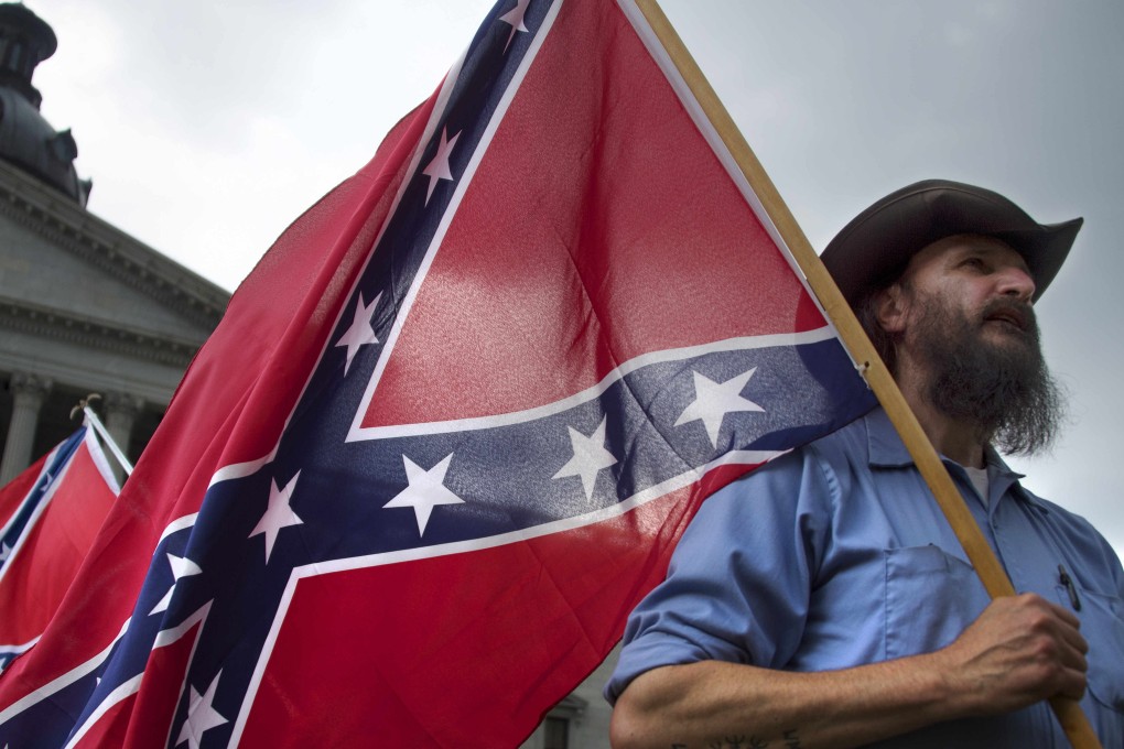 A demonstrator protesting against calls to remove the Confederate flag, seen by many as a reminder of racism's legacy, from the grounds of the state house in South California, in the wake of the shootings at the church in Charleston. Photo: AFP