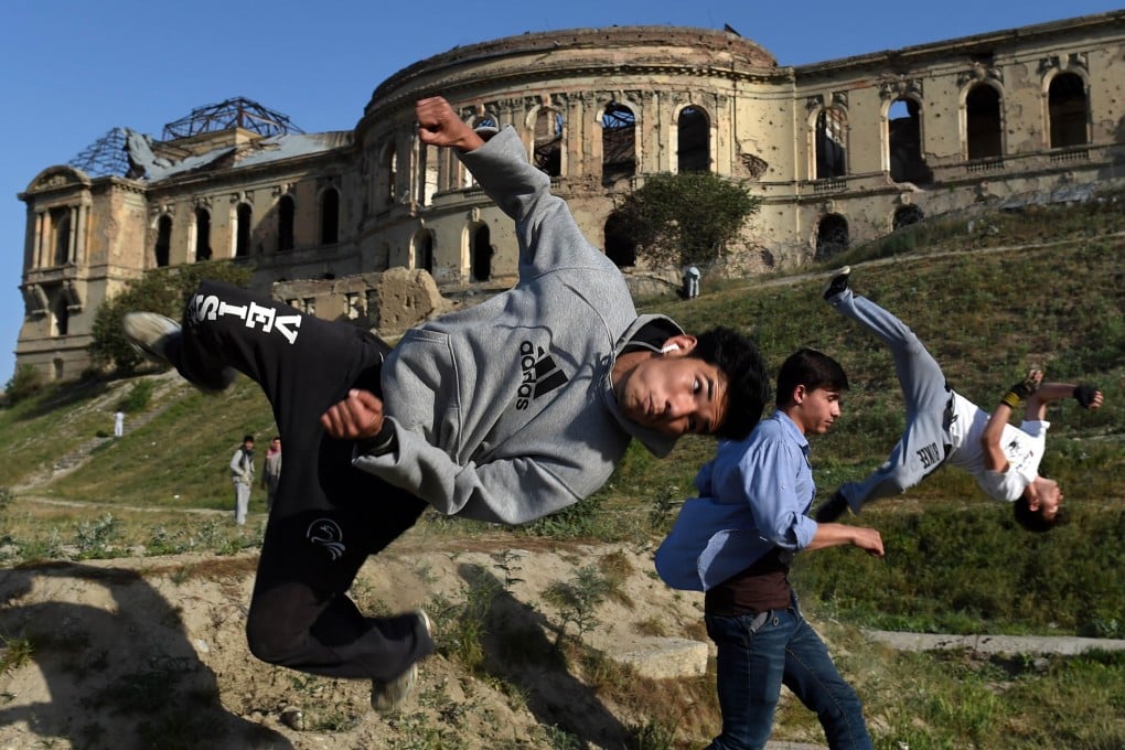 Afghan boys practise their parkour skills, which combine running, acrobatics and gymnastics, in front of the ruins of Darul Aman Palace in Kabul reduced to a wreck after almost 40 years of war.Photos: AFP