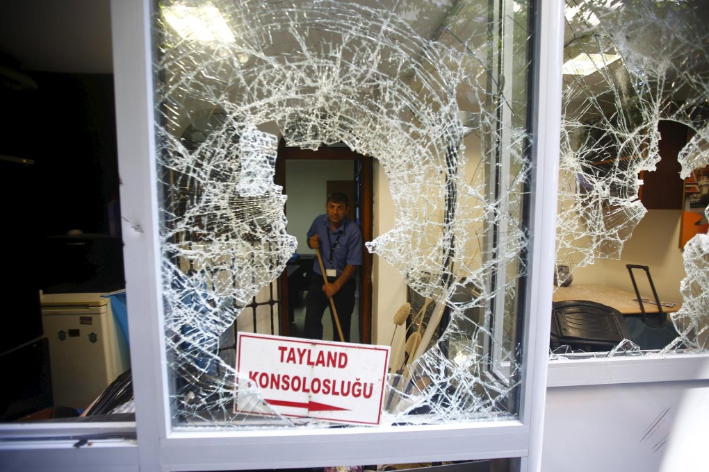 Workers clean up after the Thai consulate in Istanbul had its windows smashed and offices ransacked. Photo: Reuters