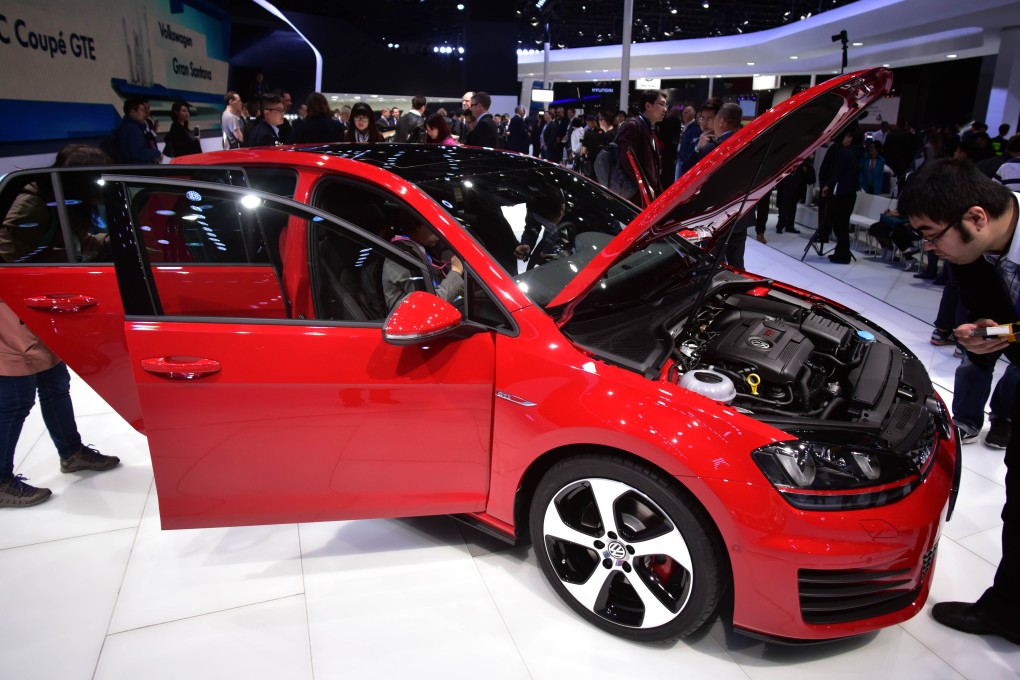 Visitors check out a car on display at an auto show in Shanghai. Photo: AFP