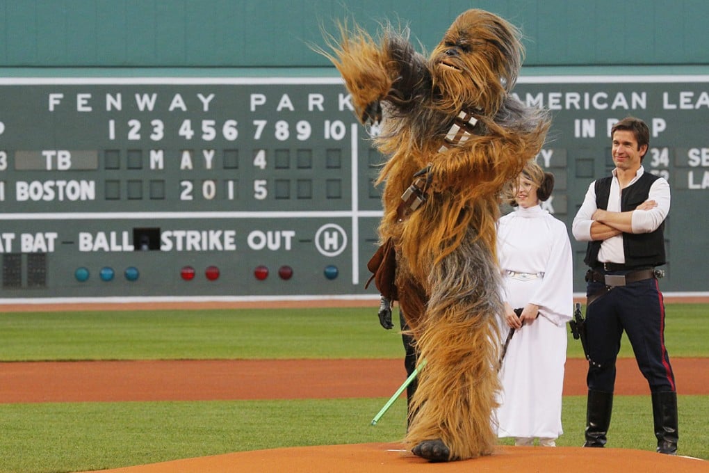 People dressed as Star Wars characters Chewbacca, Princess Leia and Han Solo throw out the ceremonial first pitch before the MLB baseball game between the Tampa Bay Rays and the Boston Red Sox at Fenway Park in Boston, Massachusetts. Photo: Reuters