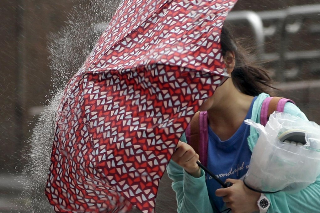 A woman walks into strong winds as Super Typhoon Chan-hom approaches. Photo: Reuters
