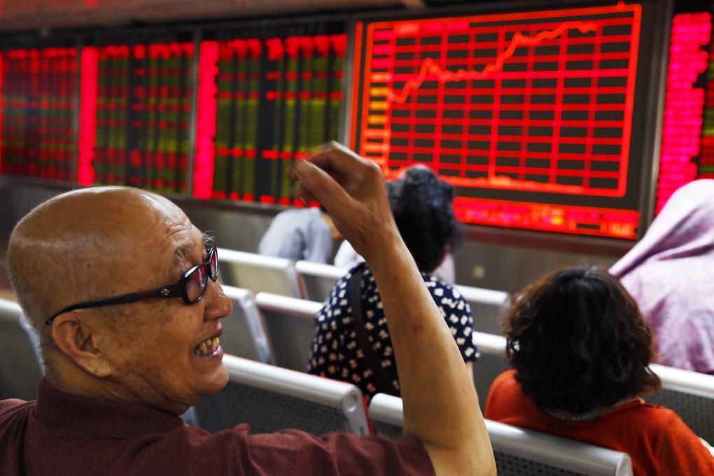 An investor smiles at a brokerage in Beijing. Photo: EPA