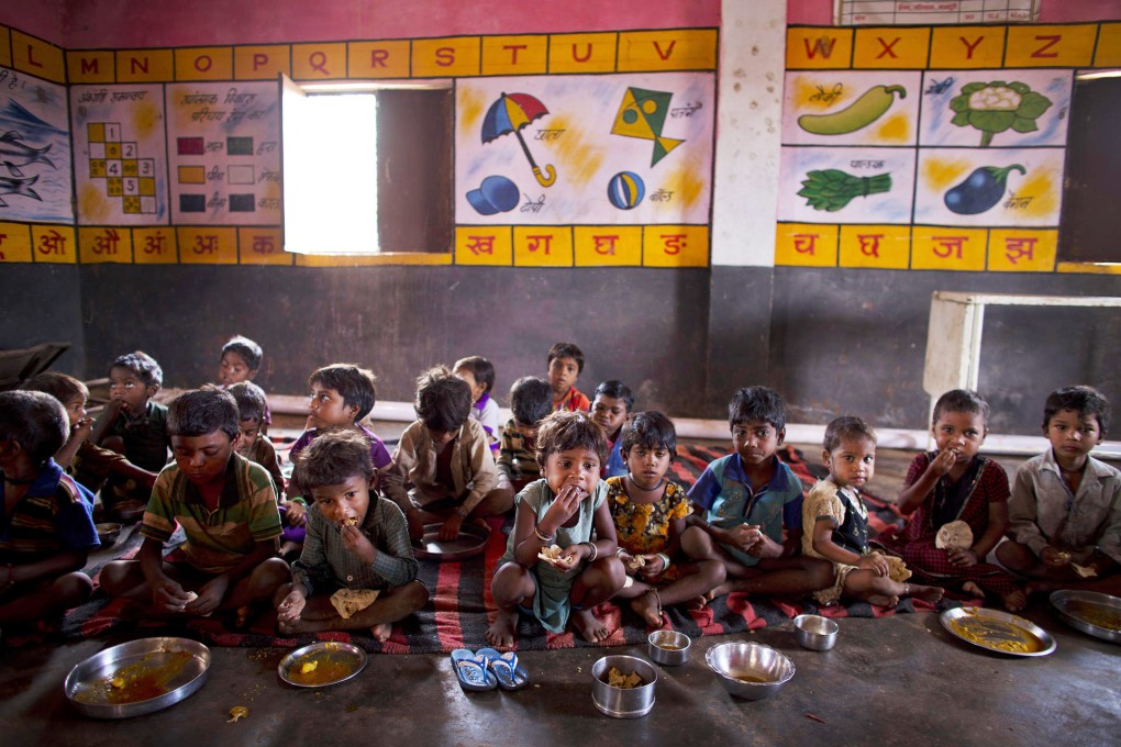 Indian children eat lunch provided by the government. Photo: AP