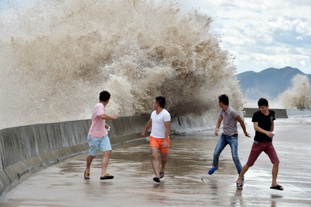 People dodge waves in China's Fujian province on Friday as super typhoon Chan-Hom approaches the country's eastern coast at high speeds. Photo: Xinhua