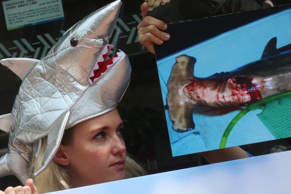 Green groups protested at the Lai Chi Kok branch of UPS yesterday demanding the company halts shipments of shark fin, which the company says is 'false'. Photo: David Wong