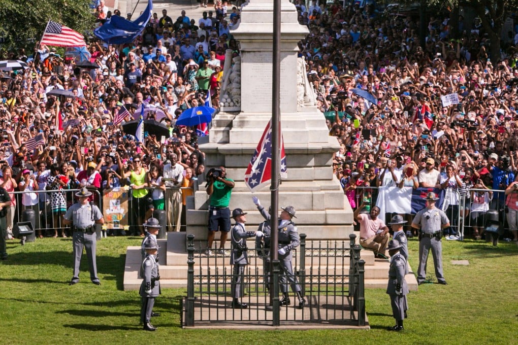 Historic moment South Carolina Highway Patrol Honour Guard removes the Confederate Battle Flag from the Statehouse.Photo: TNS