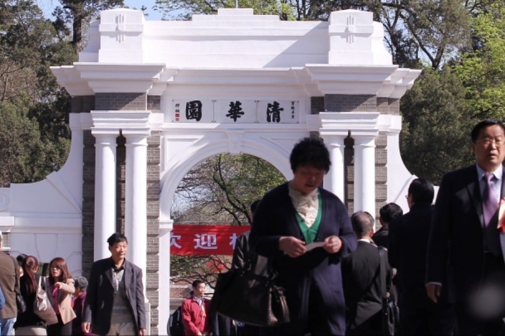 People walk in front of a historic gate in Tsinghua University, one of the best in China. Photo: Simon Song