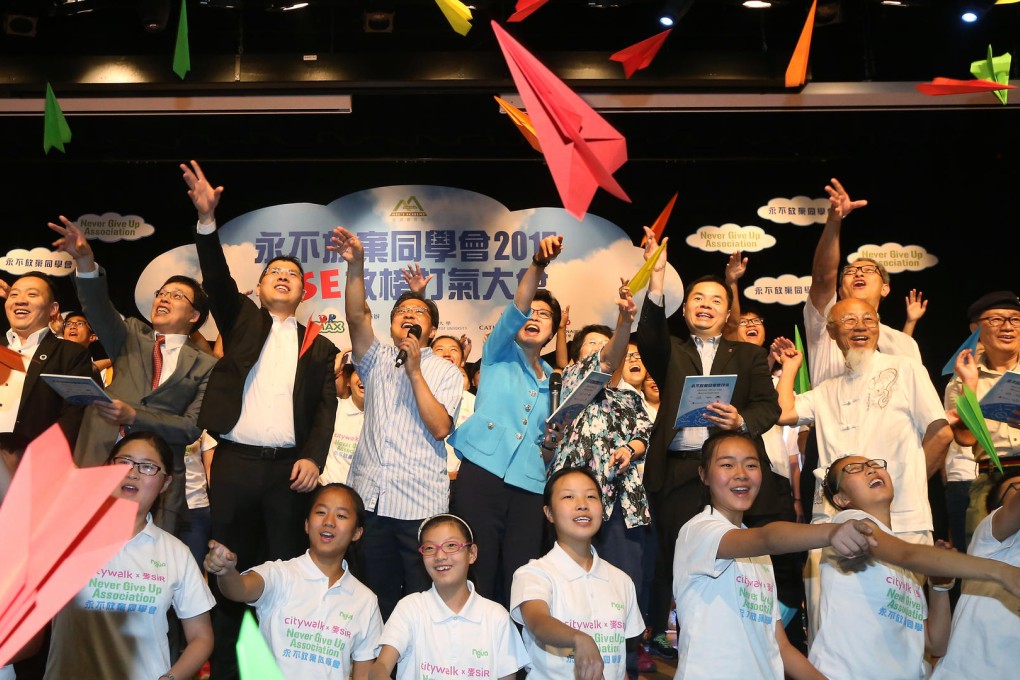 Chief Secretary Carrie lam Cheng Yuet-ngor (Second Row, from Left Fifth) takes the lead in reading out slogans with the students during Never Give Up Association 2015: DSE Cheer Up Party at the Hong Kong Baptist University in Kowloon Tong. Photo: David Wong