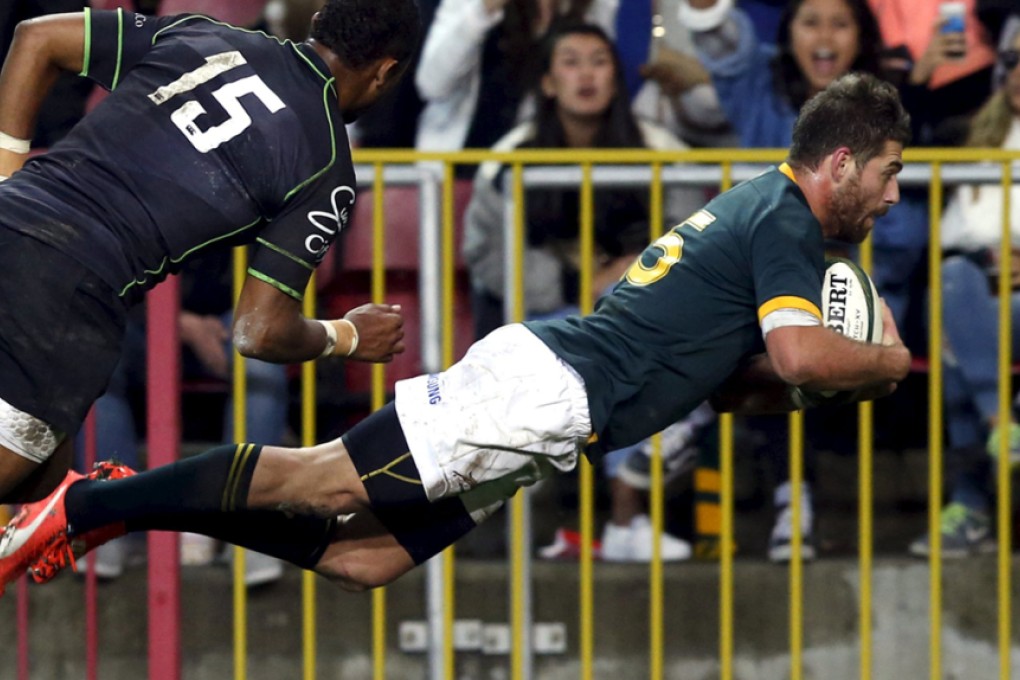 South Africa's Willie le Roux scores a try under pressure from the World XV's Delon Armitage in Cape Town, South Africa on Saturday. Photo: Reuters