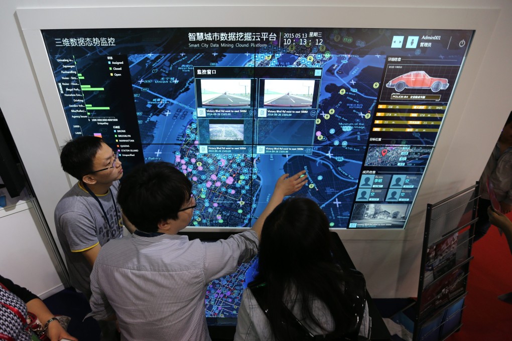 Visitors look at a screen displaying a smart city system at the 18th China Beijing International High-Tech Expo in Beijing in May. Photo: EPA
