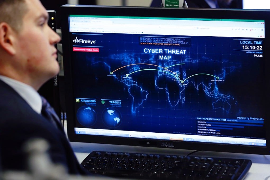 An office worker looks at a live display of cyber threats. The financial sector is taking the lead in terms of presenting a united front against cyber criminals. Photo: Reuters