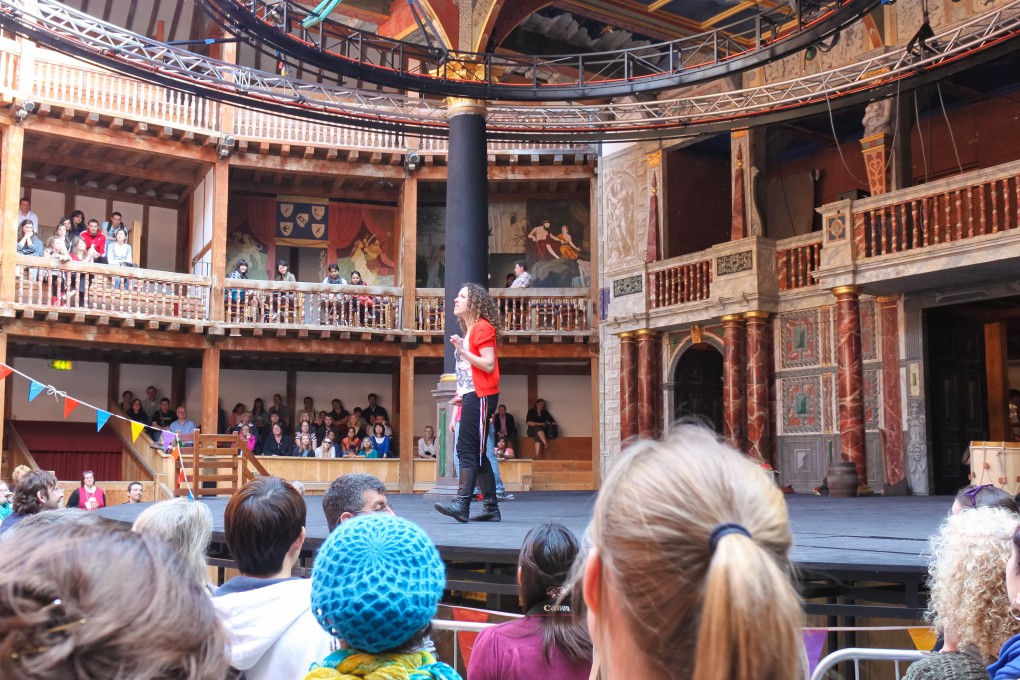People watch a stage production at The Globe in London.