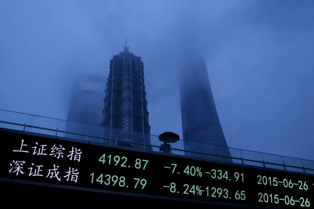 The Shanghai and Shenzhen exchange indices are shown in an electronic board in the Pudong financial district of Shanghai. Photo: Reuters