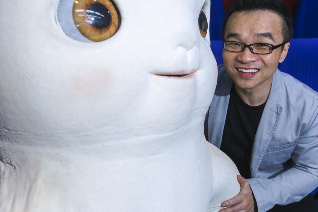 Raman Hui with a life-size model of his animated creation, Wuba.