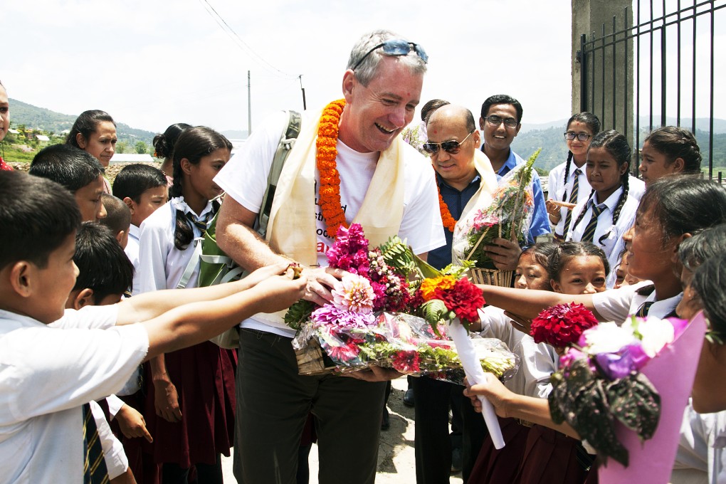 Students welcome John Wood to Shree Bagrayoginee Secondary School in Sankhu. All but three of participants there in Room to Read's girls' literacy programme lost their homes in the recent earthquakes but all have returned to school. Photo: Rishi Amatya/Room to Read
