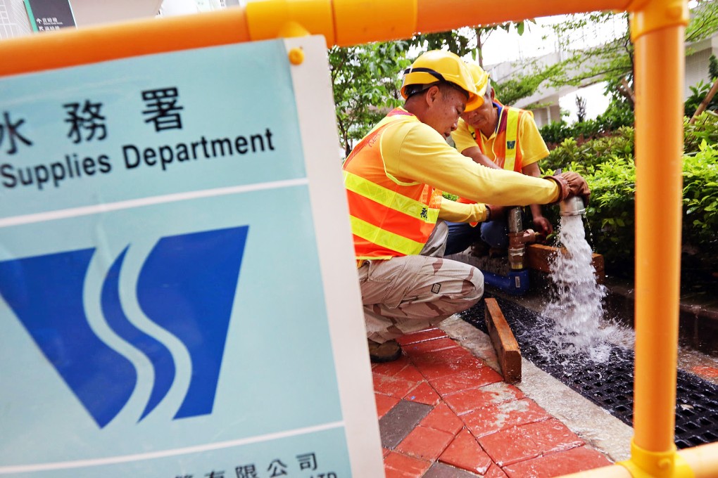 Employees of the Water Supplies Department get down to work at Kai Ching Estate in Kowloon City yesterday. Photo: Nora Tam