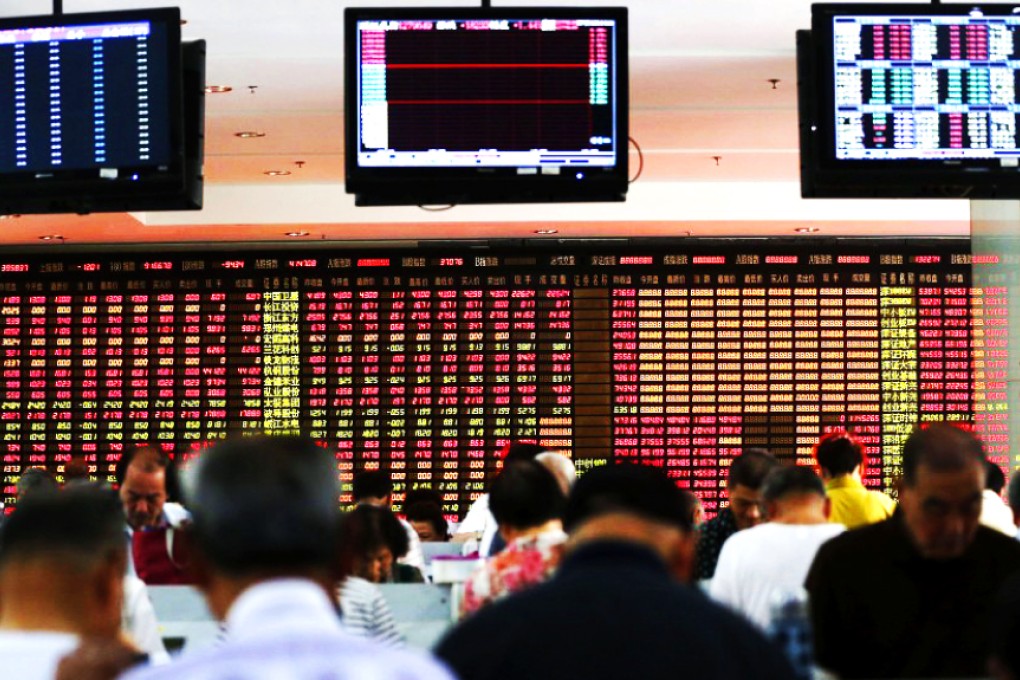 Dozens of retail investors watch the gyrations of China's stock markets at a brokerage house in Shanghai. Photo: Reuters
