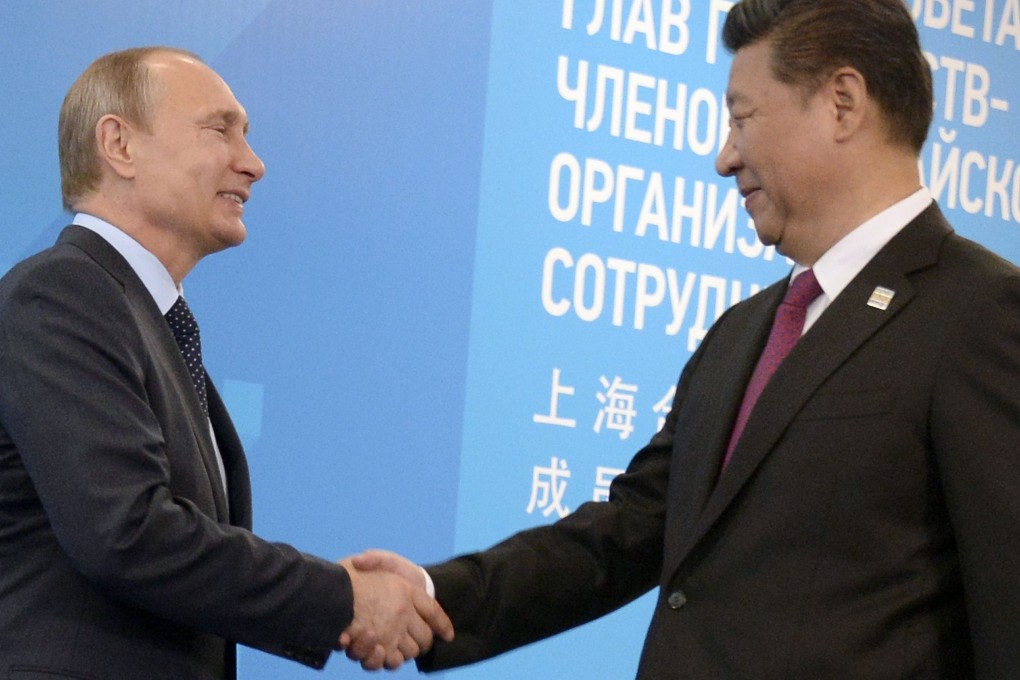 President Xi Jinping joins Russian President Vladimir Putin for a photo op in Ufa. Russia has further opened up its own economy to Chinese investment. Photo: AFP
