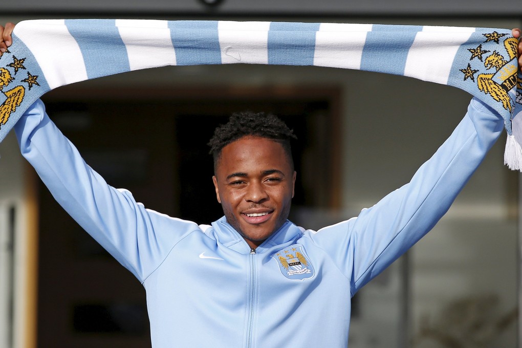 Raheem Sterling holds a Man City scarf. Photo: Reuters