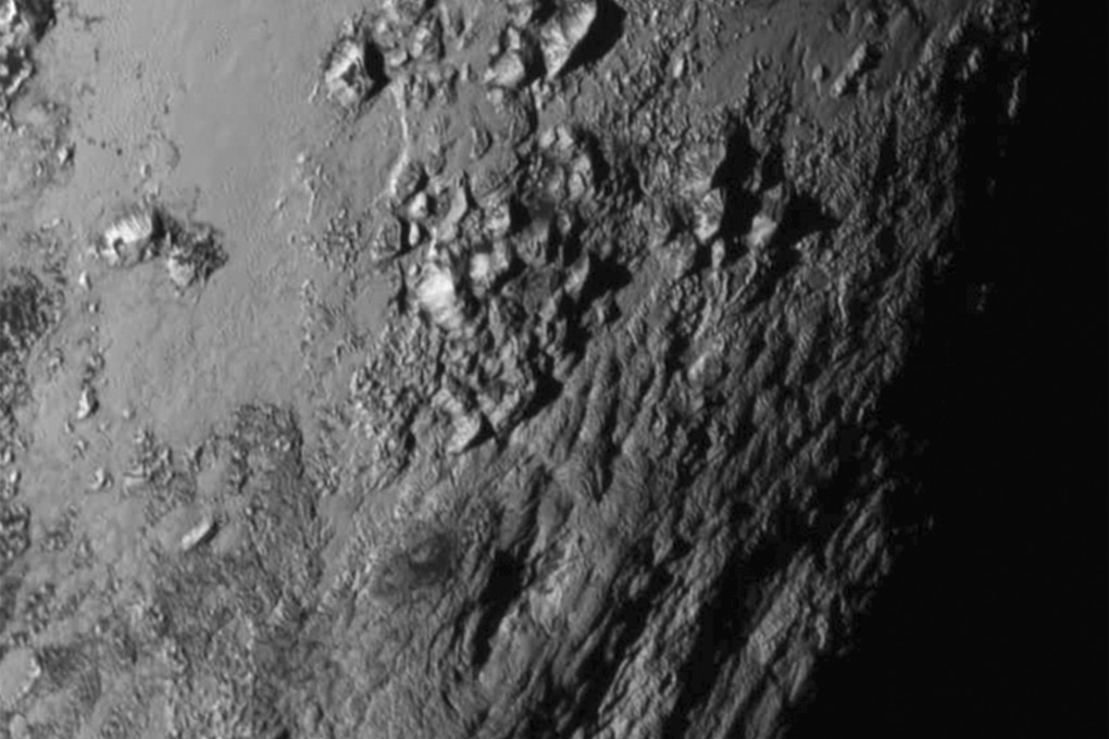 The first close-up photo of Pluto released by NASA reveals a surprise - mountain ranges rising to a height of about 3,400 metres. Photo: Reuters