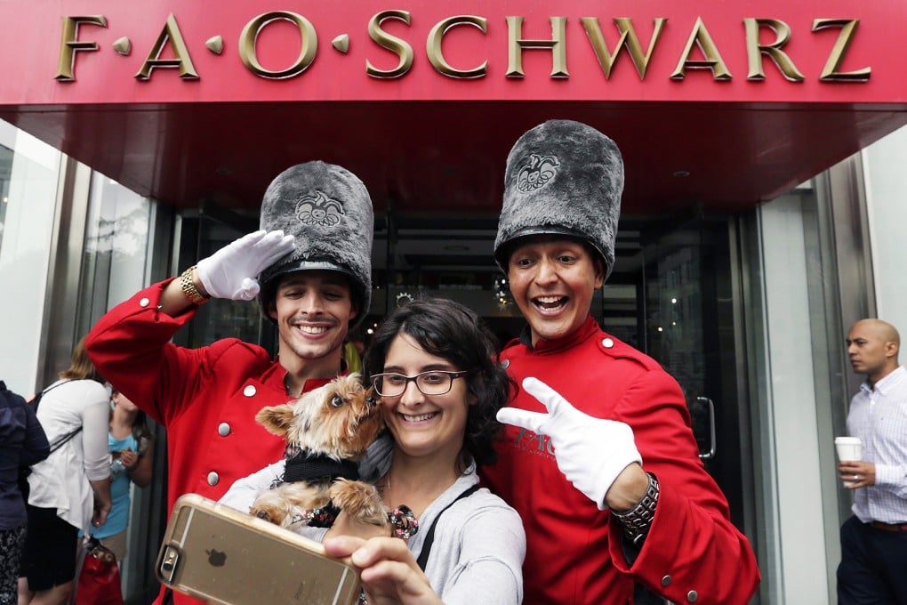 A customer takes a selfie with the "toy soldiers" of FAO Schwarz on Wednesday. The store has been in New York since 1870. Photo: EPA