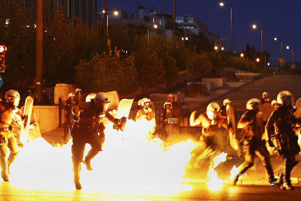 Police clash with firebomb-throwing anti-austerity protesters on the streets of Athens on Wednesday night. Photo: Reuters