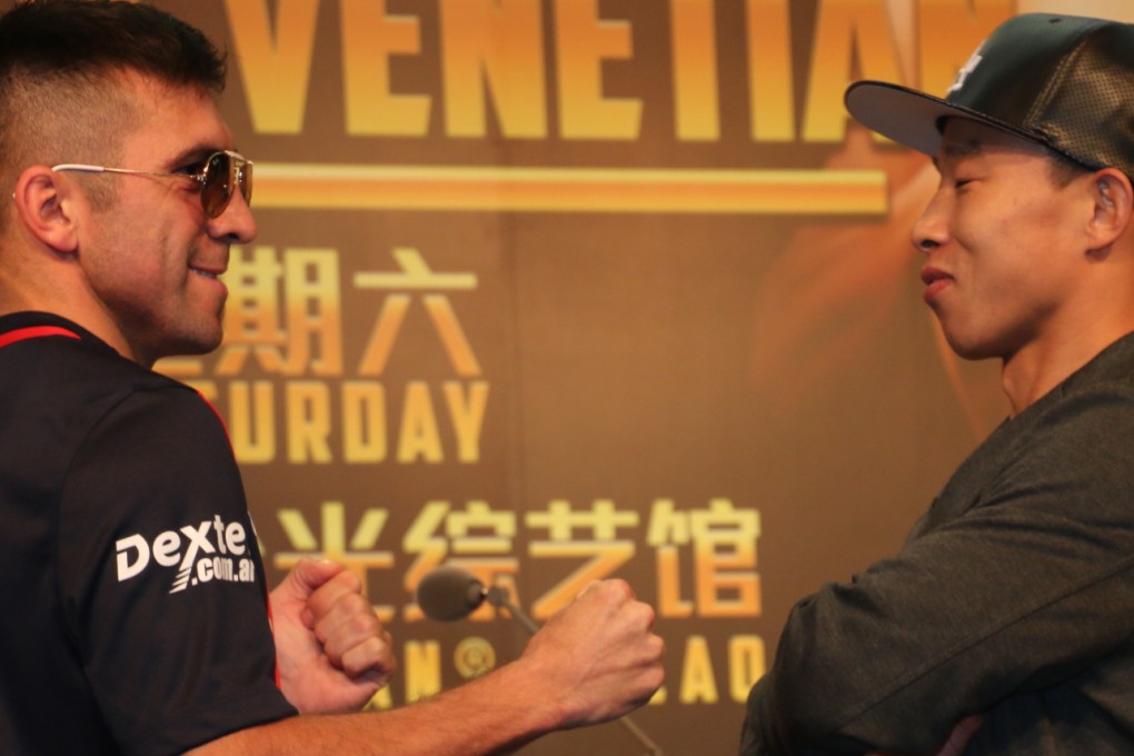 Argentina's Cesar Cuenca and China's Yang Lianhui face off at a media conference for "Victory at the Venetian". They will battle for the vacant International Boxing Federation junior welterweight world title on Saturday. Photos: Unus Alladin