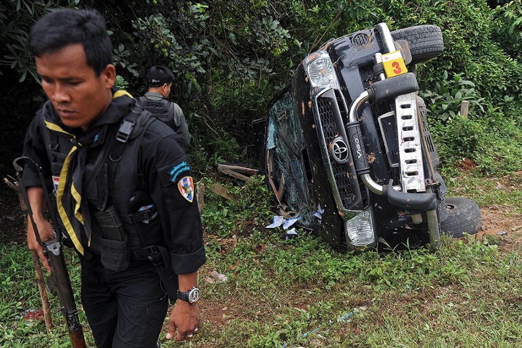A Thai ranger inspects the site of a roadside  attack by suspected separatist militants on an army vehicle. Photo: AFP