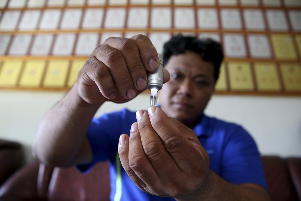 Pig farm owner Sam Wang demonstrates how to use an iSperm kit in Yunlin. Originally designed for agriculture, developer Aidmics hopes to target the US$40 billion human fertility market. Photo: Reuters