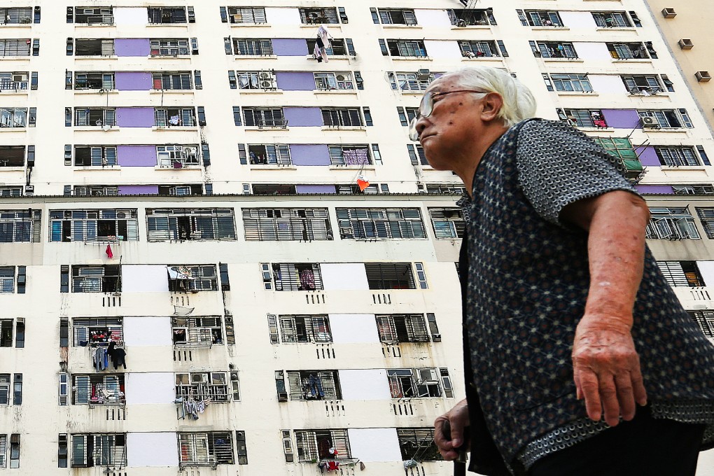 An old woman is passing by the Hing Wah 2 Estate in Chai Wan. Photo: Nora Tam