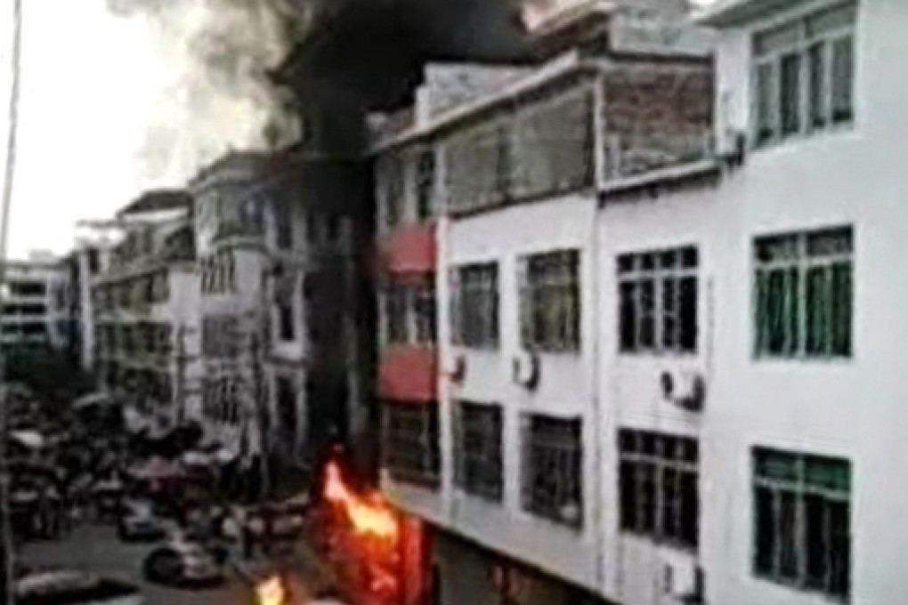 Black smoke pours from the home of a businessman in Pinghe county in China's Fujian province after the attack. Photo: Chinanews.com