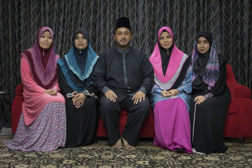 Global Ikhwan chief executive Lokman Hakim with his wives. Photos: Thomas Cristofoletti