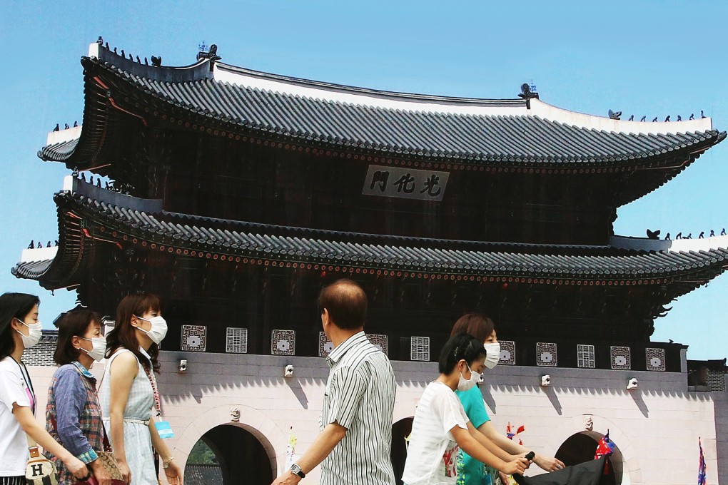 People wear masks as a precaution against an outbreak of the Mers virus in South Korea. Photo: AP