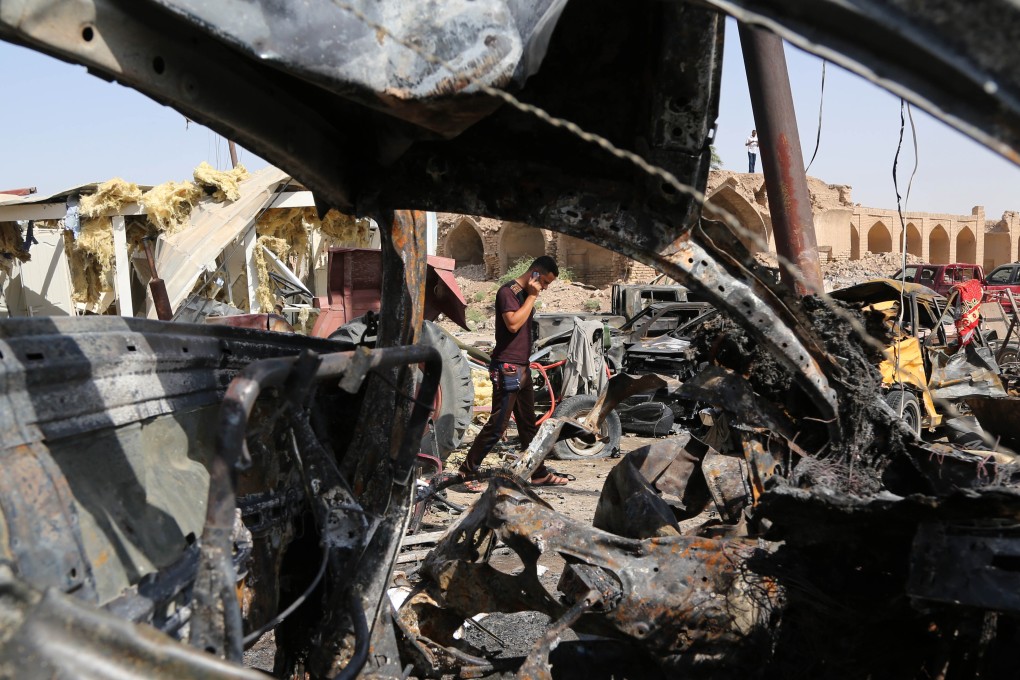 Debris is scattered at the site of a suicide car bombing at a busy market in Diyala province, in Iraq. The attack, carried out by Islamic State, killed at 115 people. Photo: AP