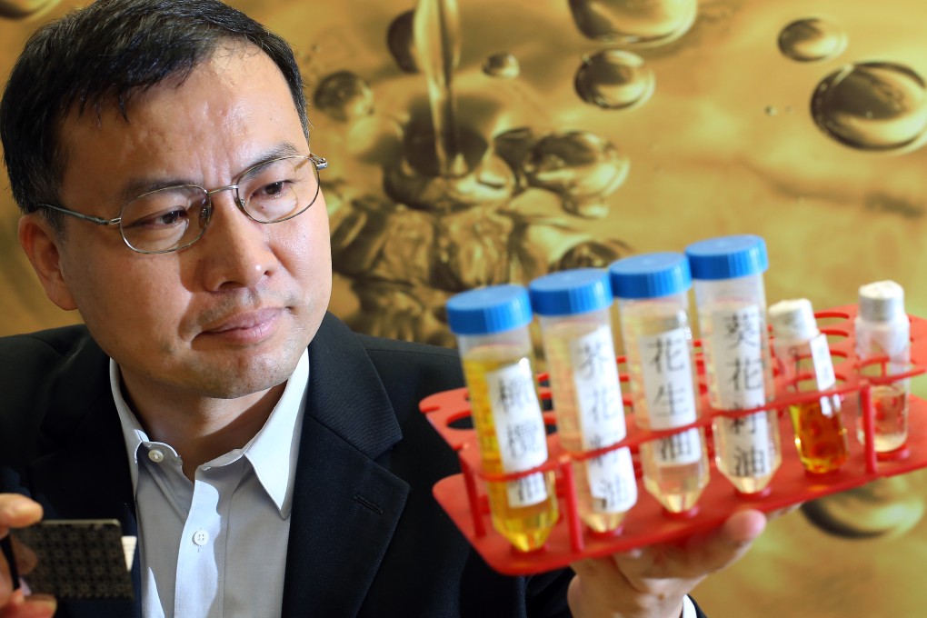 Associate Professor Yao Zhongping of Department of Applied Biology and Chemical Technology of Hong Kong Polytechnic Universtiy, shows the newly developed method for rapid authentication of edible oils and screening of gutter oils at the PolyU Campus in Hung Hom. Photo: Dickson Lee