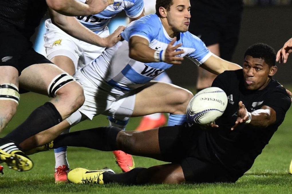 All Blacks debutant Waisake Naholo offloads as he is tackled by Argentina’s Tomas Cubelli during their Rugby Championship clash on Friday. Naholo cracked a bone in his leg during the second half and has been ruled out of playing in this year’s World Cup. Photo: AFP