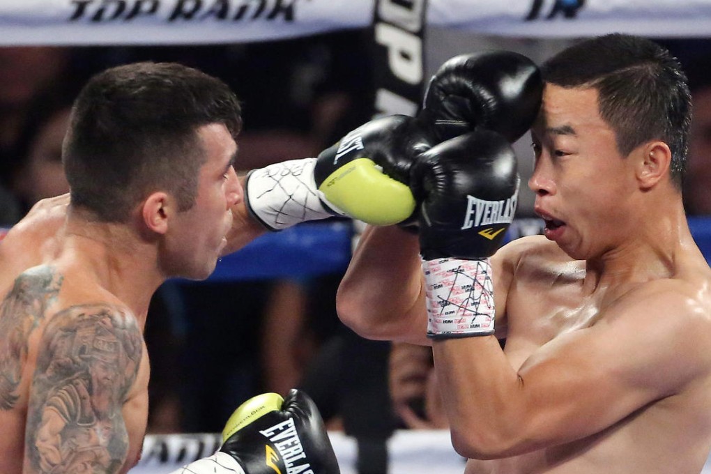 Argentina's Cesar Cuenca tries to land a punch on Yang Lianhui of China on his way to victory. Photo: SMP Pictures