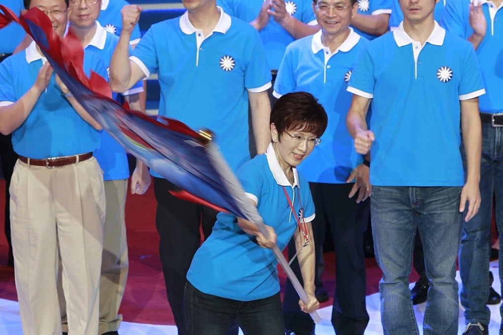Hung Hsiu-chu, a former teacher, waves a flag as she is nominated as the KMT's candidate in the January presidential election