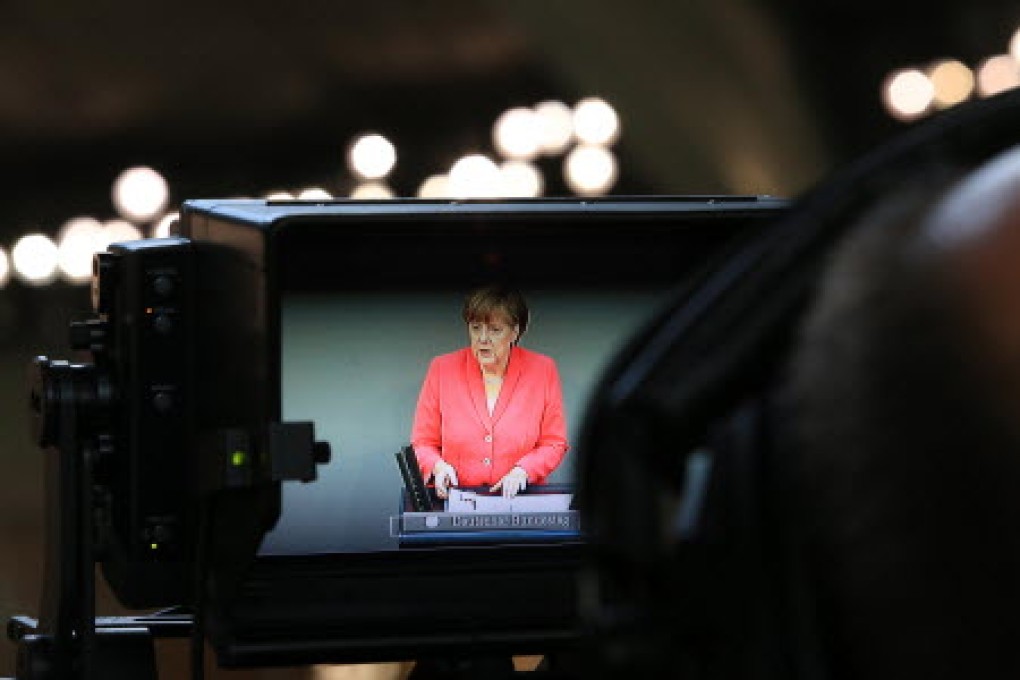 German Chancellor Angela Merkel addresses the lower house of the Bundestag in a televised speech about Greece's economic problems. Photo: Bloomberg