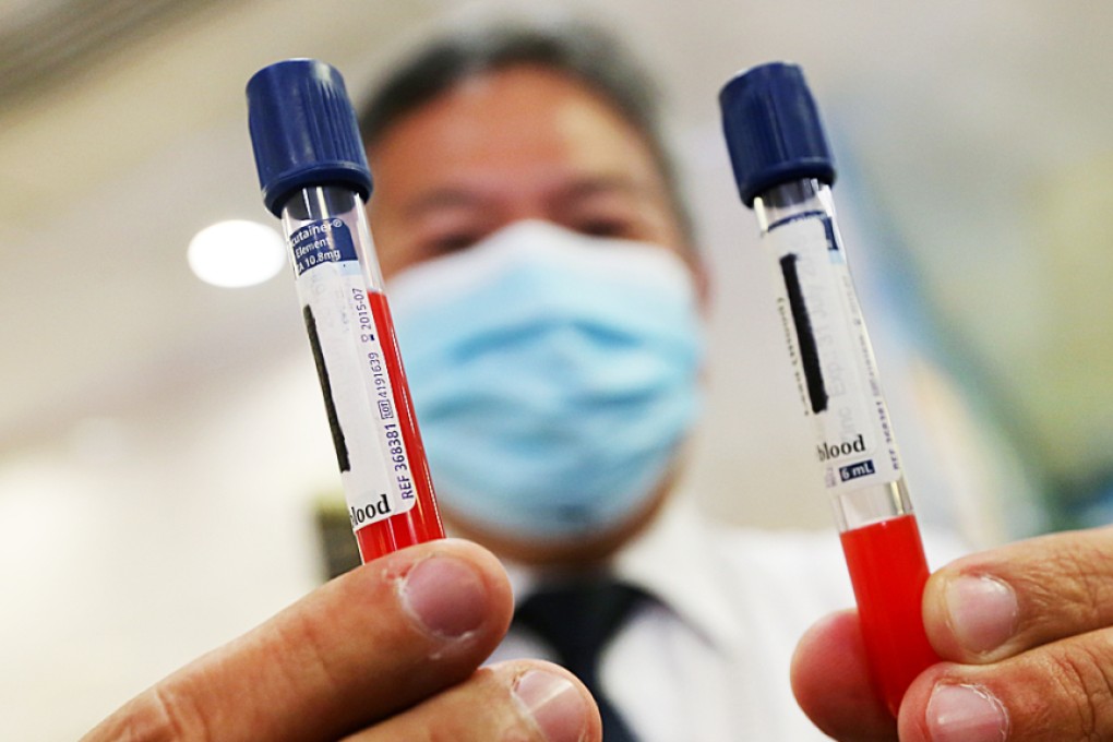Edwin Tai Wing-sang, Department operations manager of United Christian Hospital, shows blood sample during blood lead level test for Kai Ching Estate's residents at United Christian Hospital in Kwun Tong. Photo: David Wong