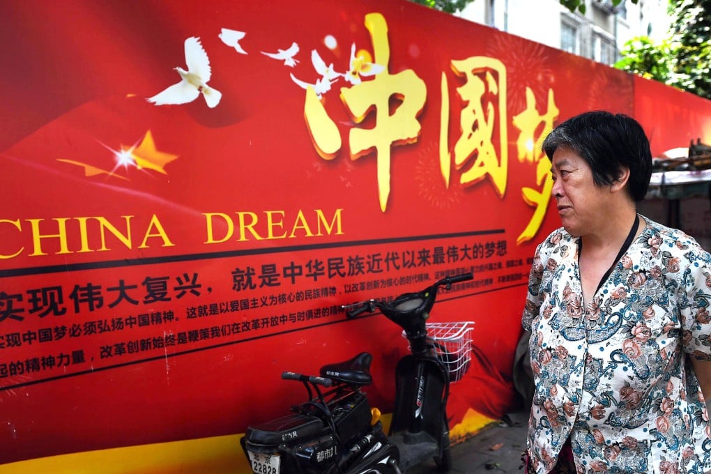 A woman looks at a banner about the "China Dream", Chinese President Xi Jinping's vision for China's future. Photo: AFP