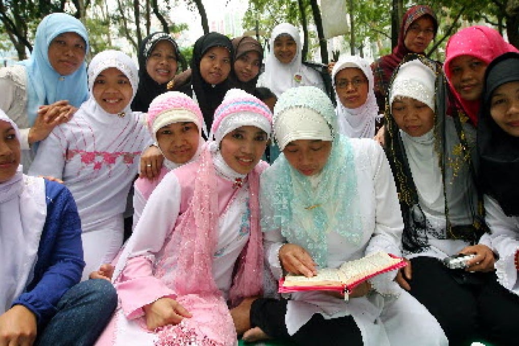 Indonesian domestic helpers in Victoria Park. Advocates and lawmakers say the current regulations leave them vulnerable to abuse and exploitation. Photo: Sam Tsang