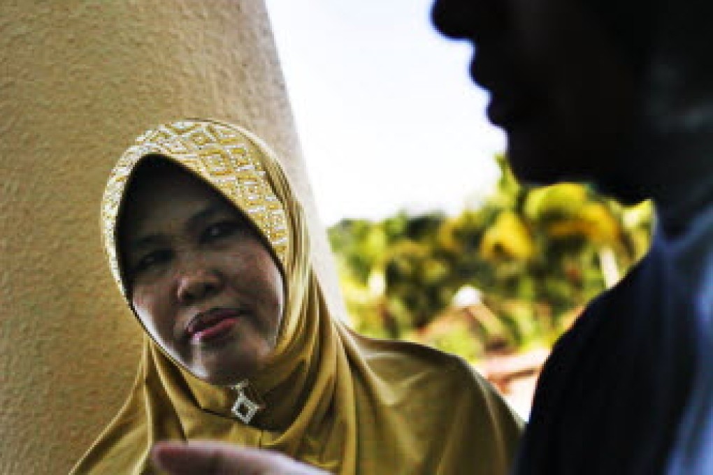 Fauziah Ariffin, the Malaysian president of the Obedient Wives Club looks on during a mass wedding ceremony in conjunction with the club's launch in Kuala Lumpur, on June 4, 2011. Rahman Roslan
