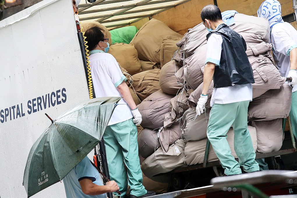 Laundry is removed for cleaning from Queen Mary Hospital on Monday. Photo: David Wong