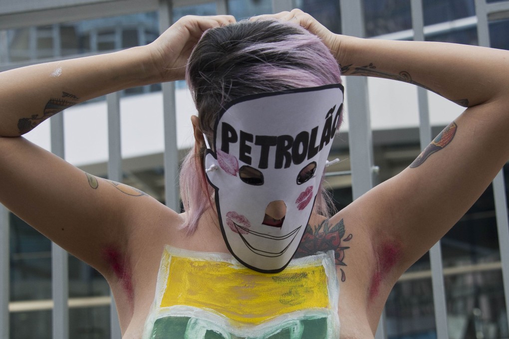 A topless protester takes part in a demonstration against the corruption scandal engulfing Brazilian state-owned oil firm Petrobras on Monday. Photo: AFP