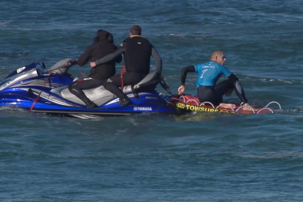 Mick Fanning sits on the back of a rescue boat after his encounter with the shark. Photo: AP