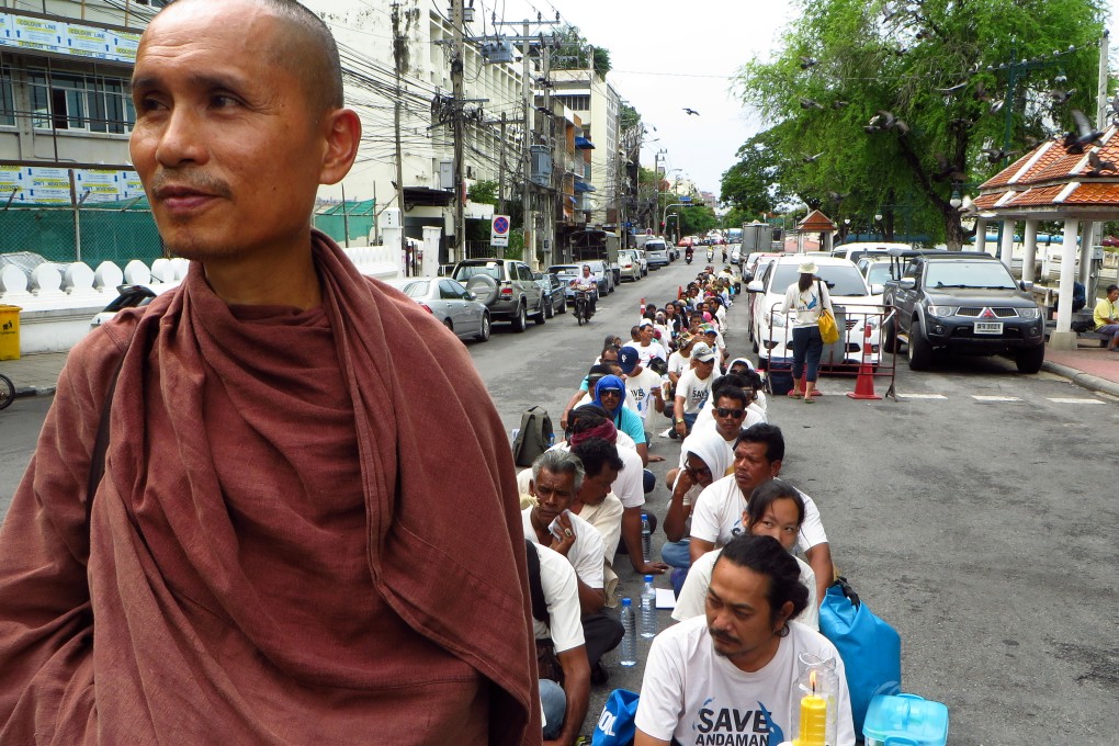 Dadodin Patavatto a Buddhist monk, leads a silent march to the Prime Minister's office in Bangkok to demonstrate against a proposed coal power plant in southern Thailand.