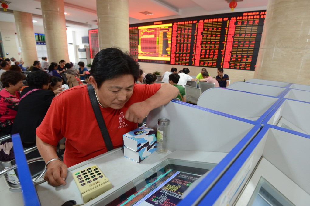 An investor in China pores over stock choices in the country's volatile stock markets. Photo: Xinhua