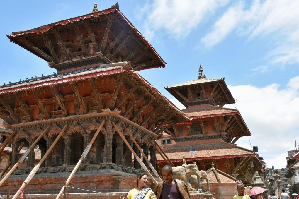 A Hindu temple is still supported by timbers at Patan Durbar Square, a UNESCO world heritage site in Kathmandu Valley in Nepal, on June 23, 2015, after it was reopened to visitors on June 15 in an attempt to bring tourism back to the region following April's devastating earthquakes. Photo: Kyodo